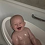 baby, bathtub, bath, bathroom, child, cute, face, happy, infant, laughing, light_reflection, metal_handle, person, plastic_seat, skin, smile, toddler, water, wet, young