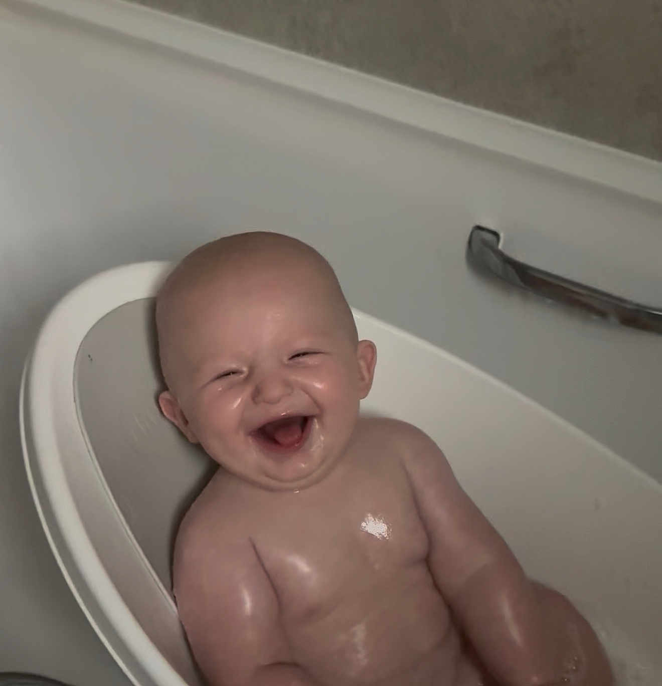 Mason is registered to the contest to win money with this photo: baby, bathtub, bath, bathroom, child, cute, face, happy, infant, laughing, light_reflection, metal_handle, person, plastic_seat, skin, smile, toddler, water, wet, young