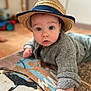 Julian a rejoint le concours — aidez-le/la à gagner de superbes lots ! baby, child, hat, straw_hat, gray_sweater, rug, floor, indoor, portrait, face, hand, curious, wide_eyes, cozy, cute, infant, crawling, patterned_rug, soft_focus, expression