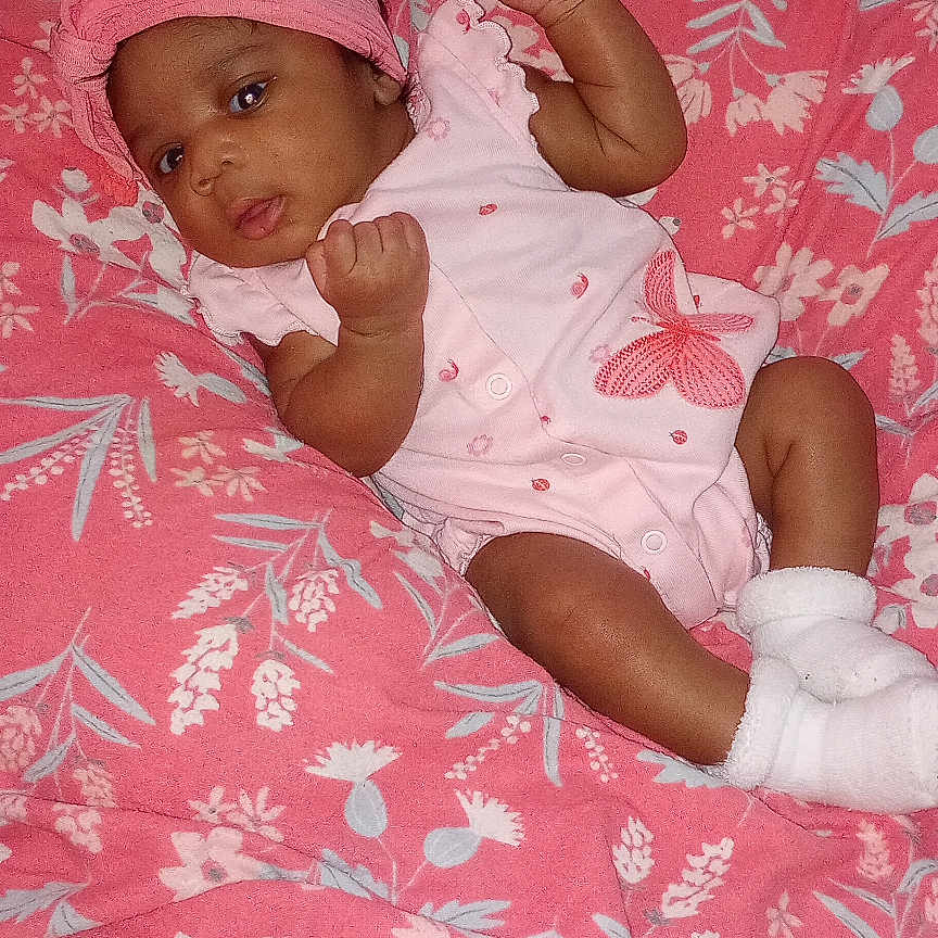 I'Vey joined the competition — help win amazing prizes! baby, infant, pink, blanket, headband, onesie, socks, cushion, floral_pattern, indoor, child, person, cute, young, lying_down, resting, comfort, soft, portrait, cozy