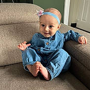 Aniyah joined the competition — help win amazing prizes! baby, child, indoor, couch, sofa, blue_clothing, headband, flower, happy, smiling, feet, toes, person, infant, seated, furniture, home, portrait, cute, small