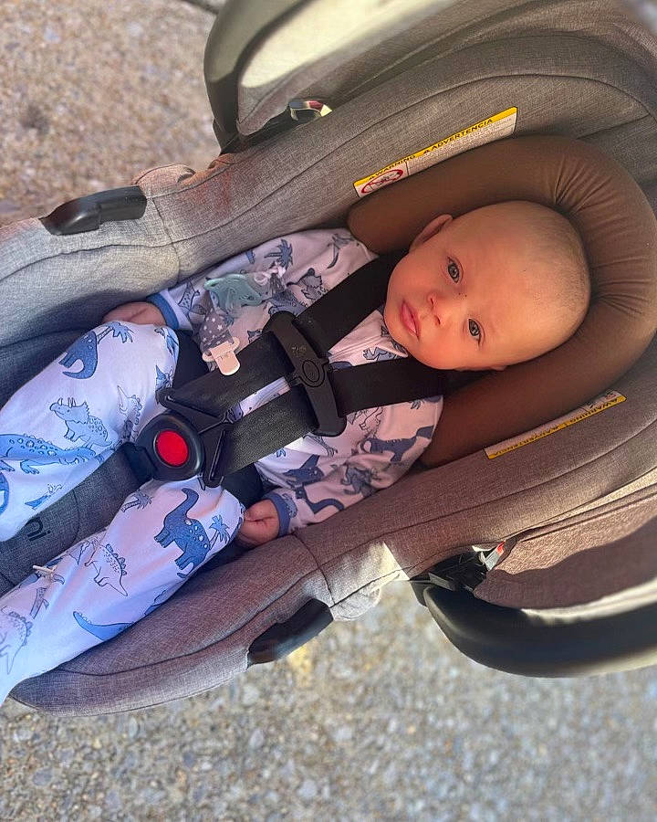 Kingston is registered to the contest to win money with this photo: auto_part, baby, baby_carriage, baby_products, baby_toddler_clothing, bag, baggage, carmine, child, comfort, fashion_accessory, infant_bed, musical_instrument_accessory, pattern, person, personal_protective_equipment, sitting, toddler