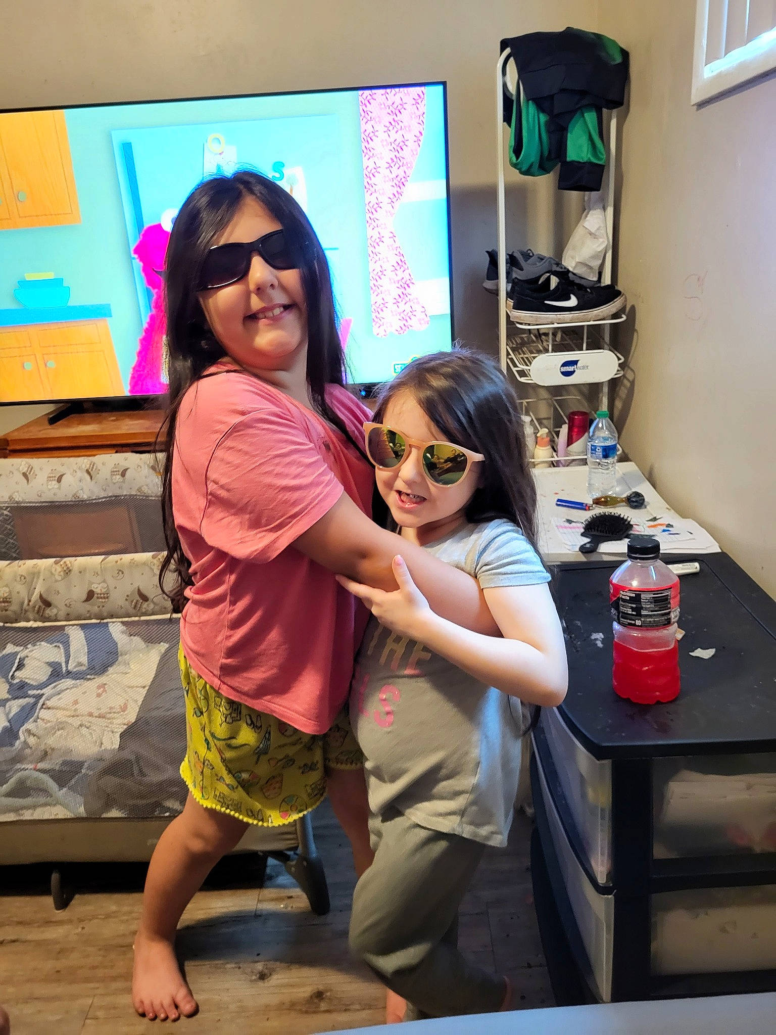 Alyssa Valdez is registered to the contest to win money with this photo: barefoot, child, event, eyewear, fun, goggles, happy, joy, leisure, magenta, party, person, pink, smile, snapshot, standing, summer, sunglasses, table, toddler