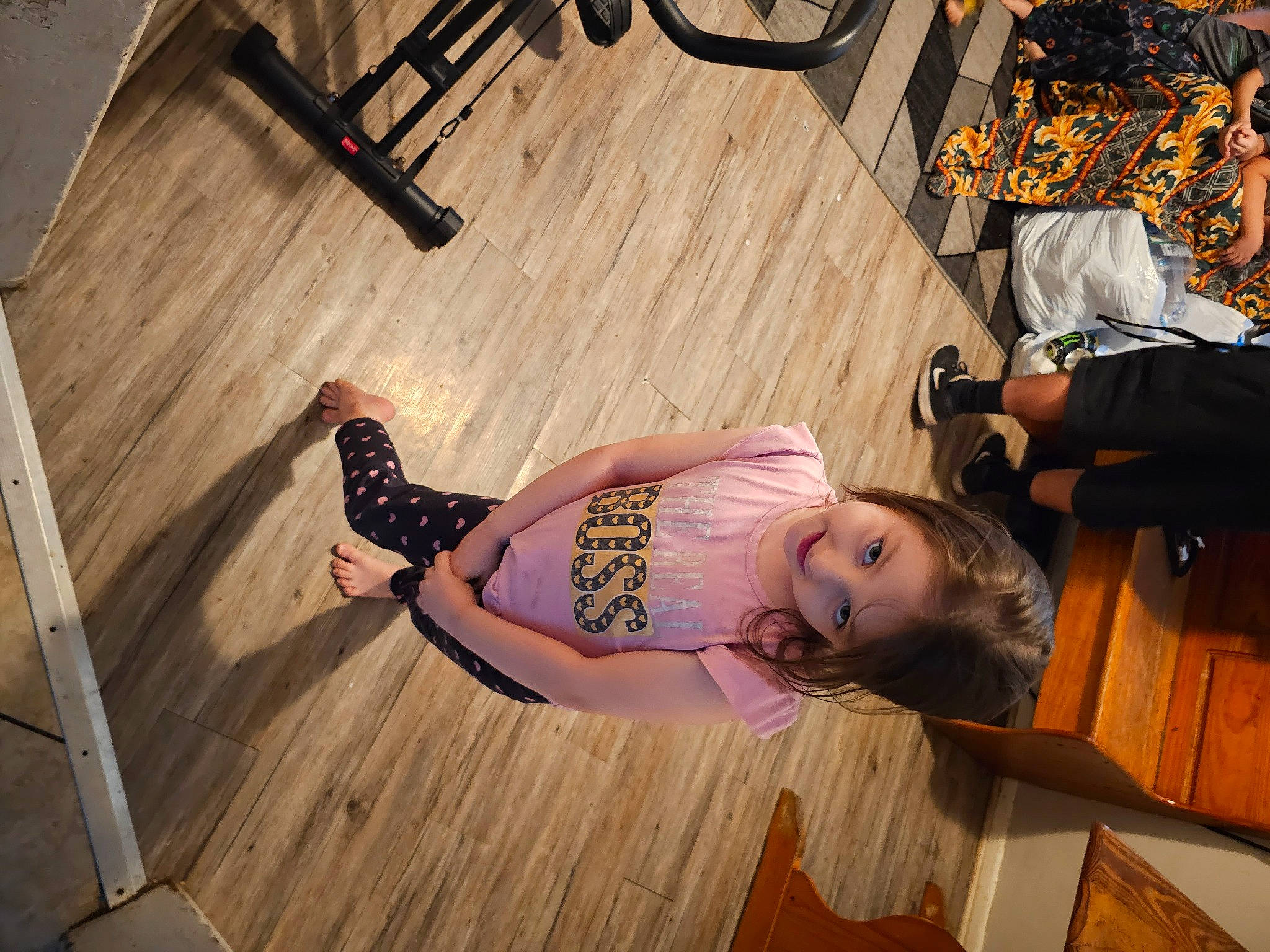 Maleah Valdez is registered to the contest to win money with this photo: abdomen, brown_hair, cool, fashion, fawn, floor, flooring, fun, hardwood, human_leg, knee, laminate_flooring, long_hair, person, sitting, sunglasses, thigh, trunk, waist, wood