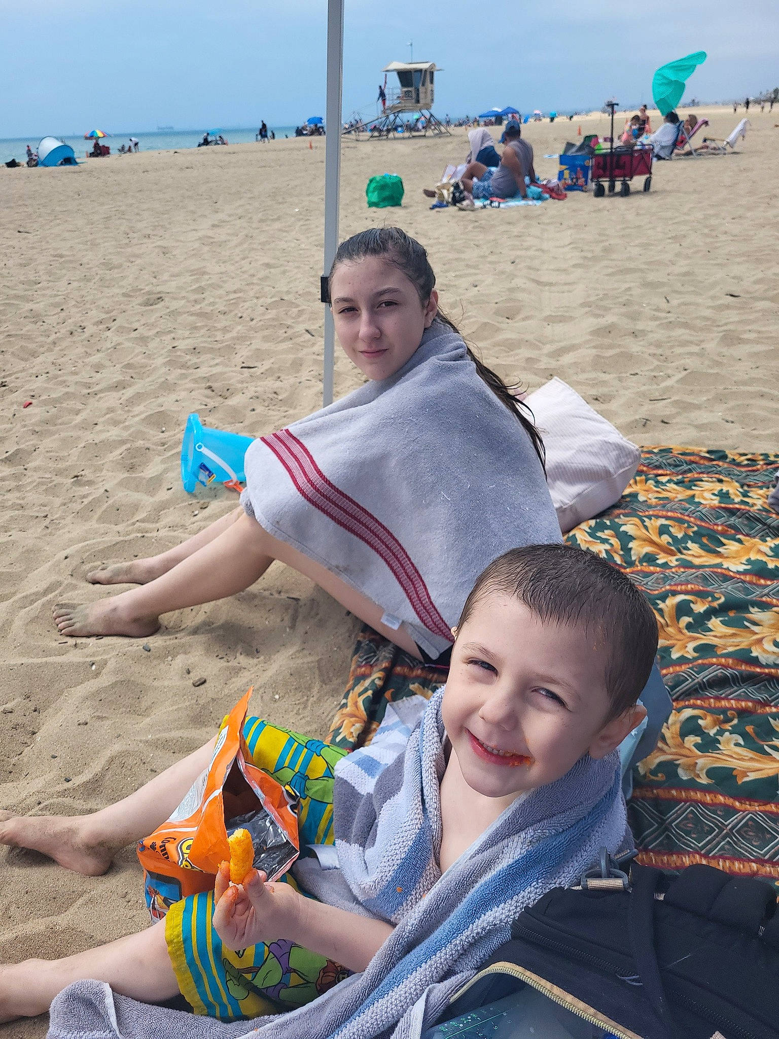 Alana Valdez joined the competition — help win amazing prizes! beach, body_of_water, event, fun, happy, hat, joy, leisure, people_in_nature, people_on_beach, person, photograph, recreation, sand, shore, sitting, sky, smile, summer, toddler