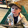 Oaklee joined the competition — help win amazing prizes! toddler, child, shopping_cart, hat, blue_eyes, clothing, jacket, pants, indoor, store, aisle, floor, person, young_child, curious, grip, seat, shopping, casual_wear, expression