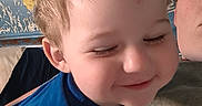 Oaklee is registered to the contest to win money with this photo: child, toddler, smiling, blue_shirt, adult, glasses, indoor, face, portrait, affection, candid, leisure, casual_clothing, person, head, closeup, happy, young_child, human, wall