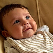 Thomas is registered to the contest to win money with this photo: baby, child, face, smile, blue_eyes, striped_clothing, cheeks, arm, hand, infant, portrait, cute, skin, hair, sitting, cozy, indoor, closeup, happy, soft_light