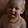 Martin participe au concours pour gagner de l'argent avec cette photo : baby, child, portrait, smile, blonde_hair, necklace, skin, cheeks, hand, arm, torso, closeup, infant, cute, expression, indoors, warm_lighting, soft_focus, person, head