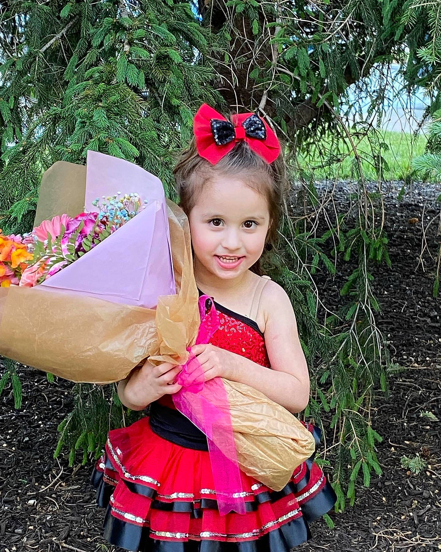 Emerson is registered to the contest to win money with this photo: baby_toddler_clothing, child, day_dress, event, fashion, fun, grass, happy, head, headpiece, insect, joy, magenta, people_in_nature, person, petal, pink, plant, red, smile