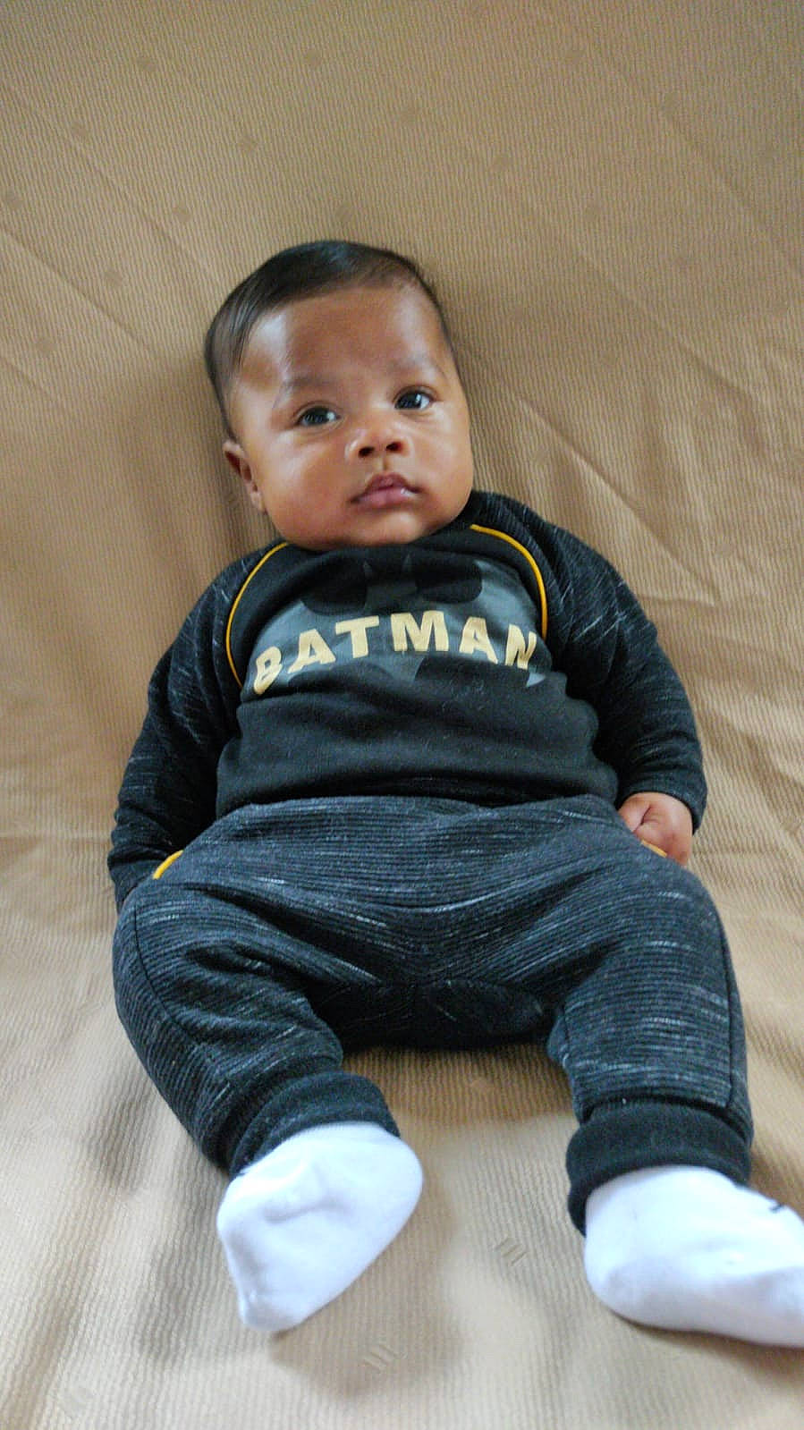 Kylian participe au concours pour gagner de l'argent avec cette photo : baby, baby_toddler_clothing, cheek, child, comfort, eye, face, floor, flooring, hand, head, human_body, leg, nose, outerwear, person, skin, sleeve, sock, standing