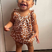 Trú is registered to the contest to win money with this photo: toddler, child, smiling, standing, giraffe_pattern, dress, white_shoes, frilly_socks, indoor, carpet, cute, happy, person, face, young_child, baby, hair_beads, portrait, clothing, footwear