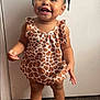 toddler, child, smiling, standing, giraffe_pattern, dress, white_shoes, frilly_socks, indoor, carpet, cute, happy, person, face, young_child, baby, hair_beads, portrait, clothing, footwear