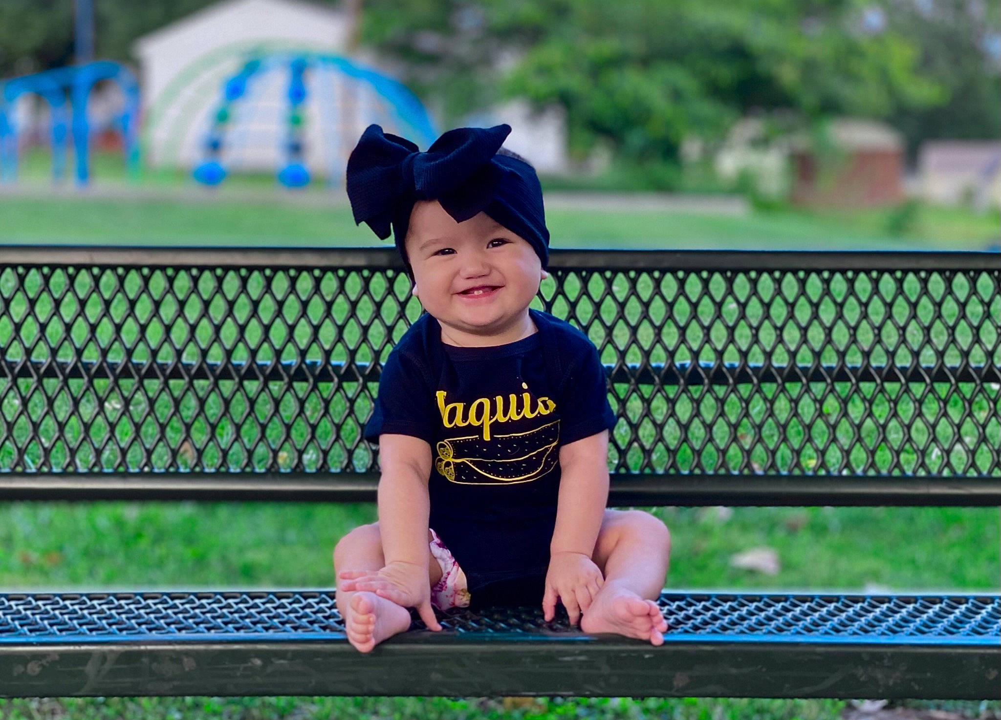 Luciana joined the competition — help win amazing prizes! baby_toddler_clothing, baseball_cap, cap, clothing, electric_blue, fence, fun, grass, happy, hat, headwear, joy, leisure, mammal, outdoor_bench, person, plant, recreation, smile, t_shirt