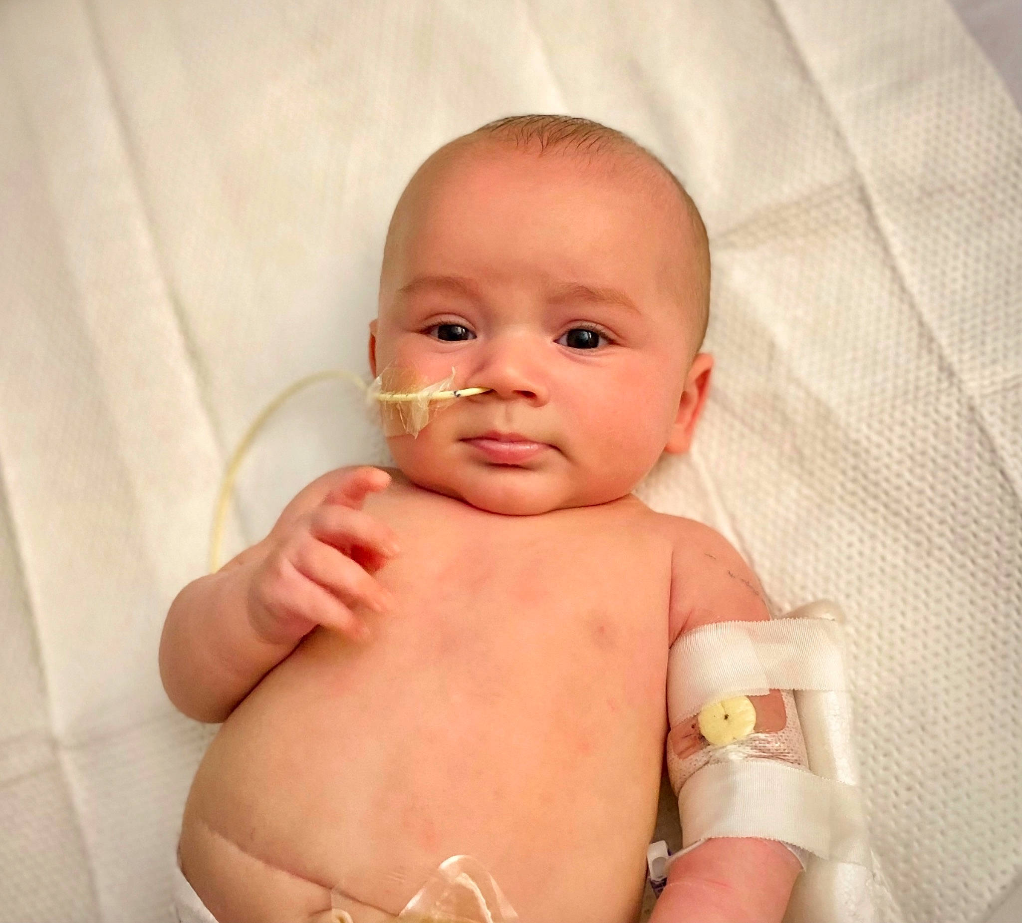 Fabian is registered to the contest to win money with this photo: arm, baby, baby_toddler_clothing, cheek, chest, comfort, eye, face, finger, gesture, hand, head, human_body, lip, nose, person, skin, stomach, thumb, toddler