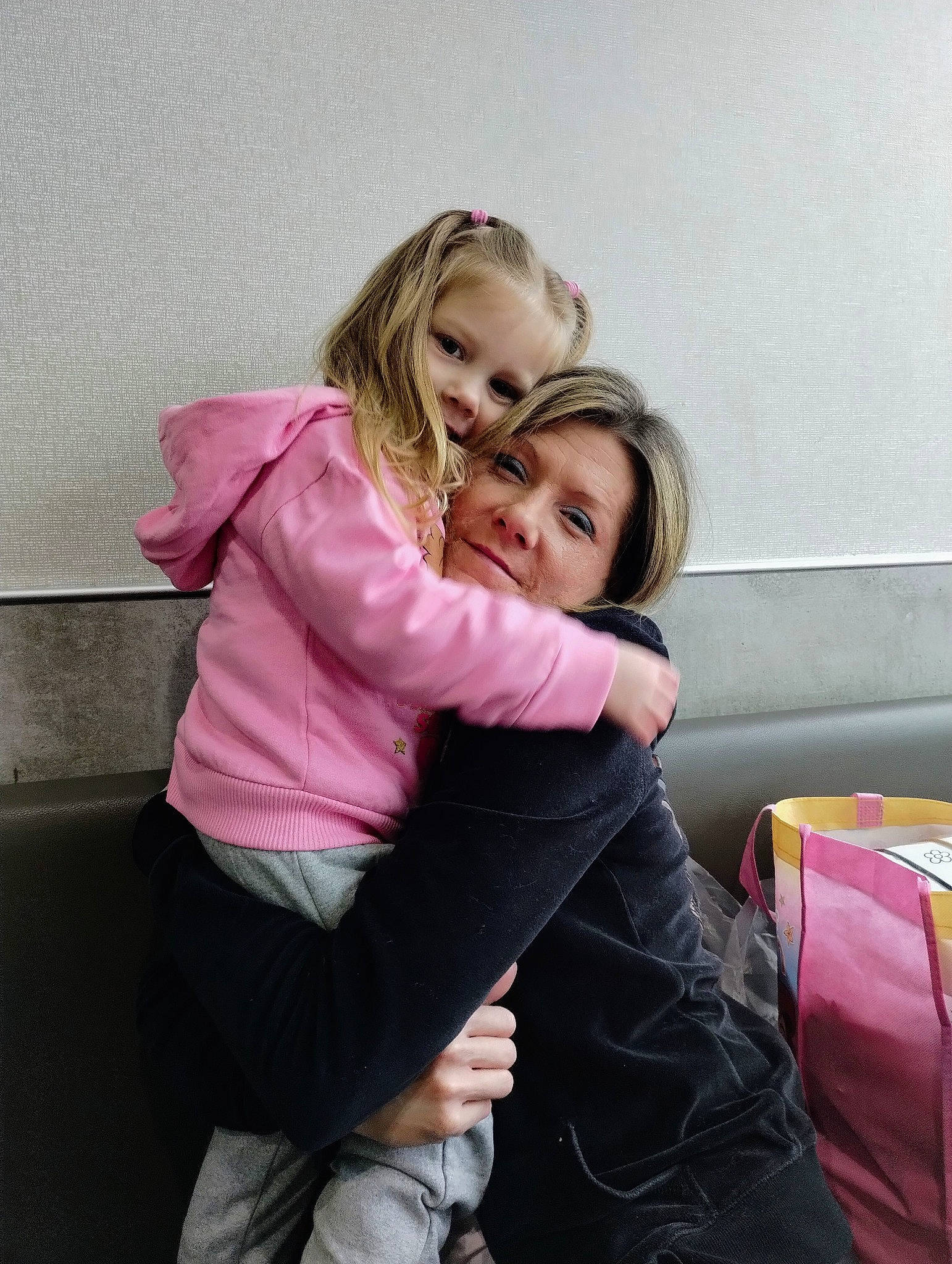 Briana is registered to the contest to win money with this photo: blond, brown_hair, child, comfort, event, flash_photography, fun, gesture, happy, human_leg, knee, lap, leisure, long_hair, magenta, person, pink, shoulder, sitting, smile