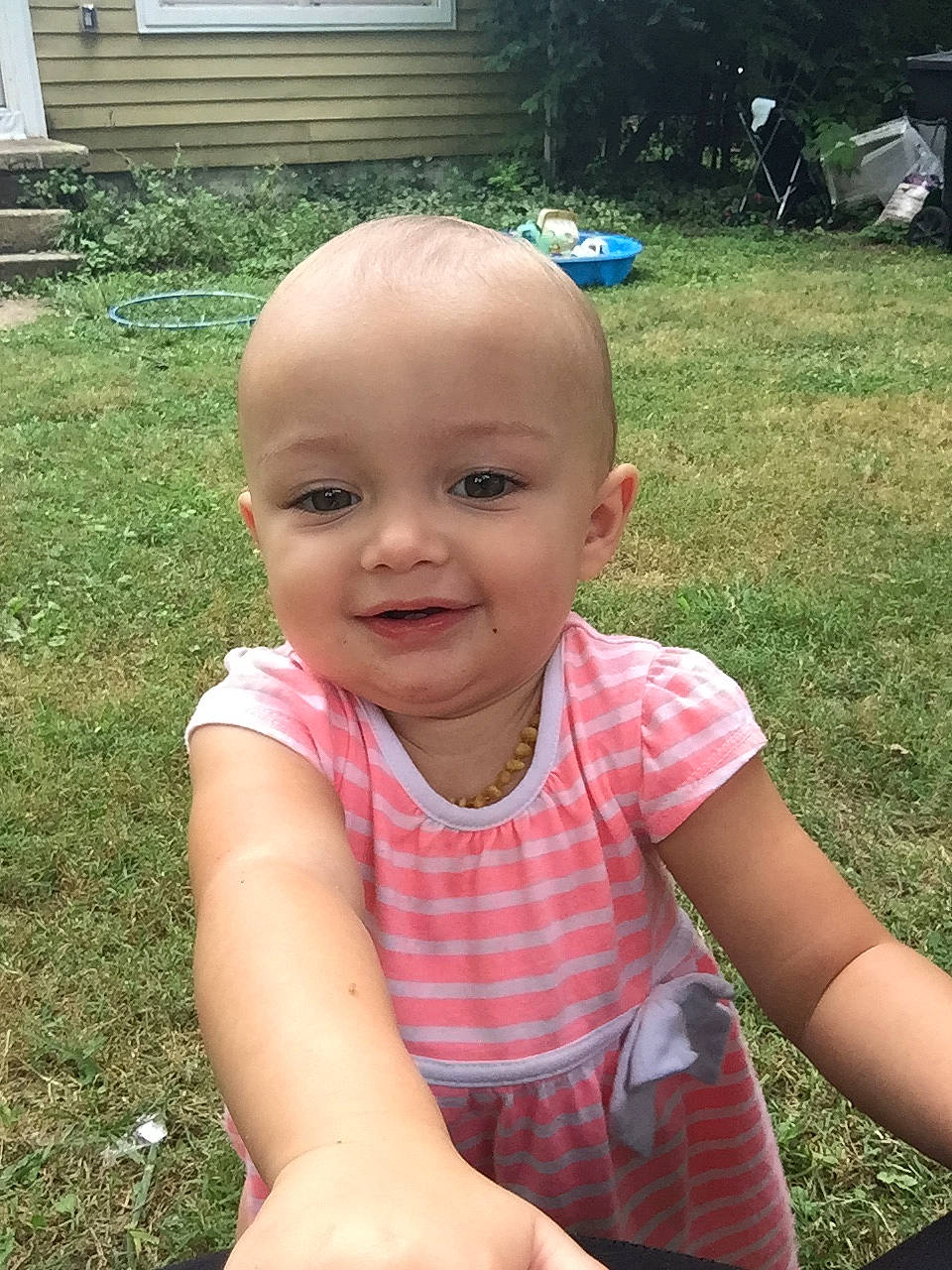 Lisa is registered to the contest to win money with this photo: baby, cheek, child, face, grass, head, joy, lip, person, skin, smile, summer, toddler