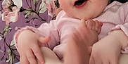 Briella is registered to the contest to win money with this photo: baby, infant, smiling, happy, diaper, hand, foot, person, lap, clothing, blanket, floral_pattern, purple, skin, cute, child, indoors, casual, comfort, playful