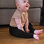 baby, child, floor, wooden_floor, sitting, happy, curious, indoor, sofa, furniture, plush_toy, clothing, pants, shirt, barefoot, face, head, cute, infant, home