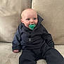 Hunter joined the competition — help win amazing prizes! baby, pacifier, black_clothing, couch, beige_couch, indoor, child, infant, seated, cute, blue_eyes, face, hands, long_pants, jacket, soft_furniture, smiling, young_child, portrait, cozy