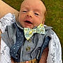 baby, infant, bow_tie, suspenders, shirt, blanket, hand, face, outdoor, grass, person, portrait, cute, newborn, clothing, fashion, closeup, smile, skin, expression