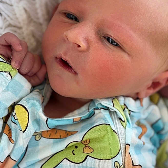 John Luke is registered to the contest to win money with this photo: baby, blanket, blue, bunny, carrot, close_up, cute, face, green, hand, infant, knitted, newborn, onesie, pattern, portrait, resting, skin, sleepy, yellow