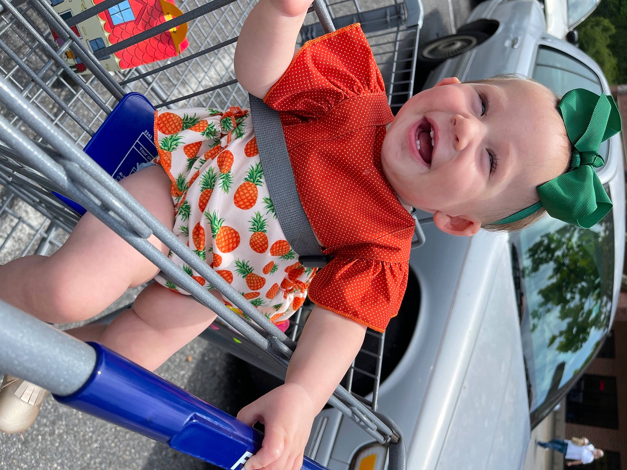 Clementine is registered to the contest to win money with this photo: automotive_exterior, child, electric_blue, fun, green, human_leg, leisure, motor_vehicle, person, product, public_space, recreation, red, shorts, snapshot, summer, t_shirt, thigh, toddler, vehicle_door