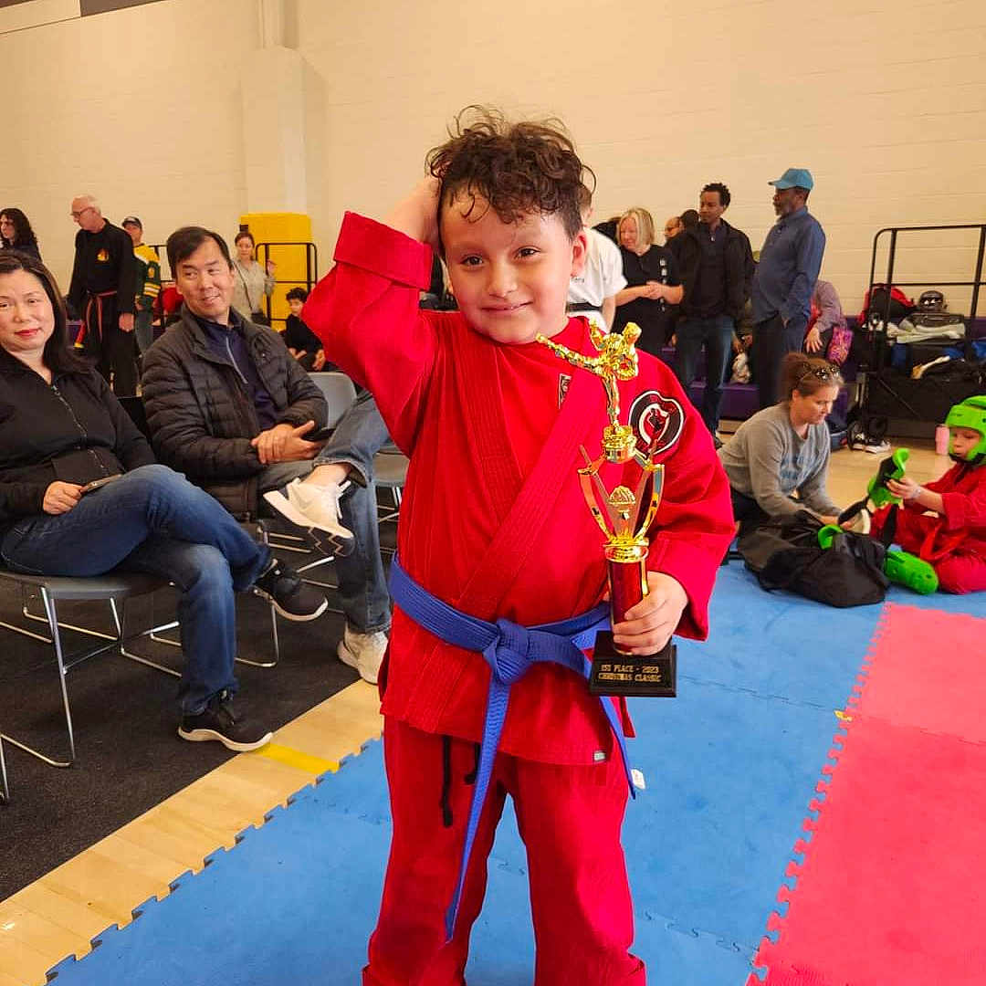 Carlos is registered to the contest to win money with this photo: adult, boy, child, clothing, costume, face, footwear, head, karate, male, man, martialarts, pants, person, photography, portrait, shoe, sport, sword, weapon