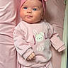 baby, infant, pink_clothing, headband, bow, blanket, cute, lying_down, indoors, child, soft_texture, bunny_print, heart_pattern, socks, baby_girl, portrait, small_hands, sleepwear, cozy, adorable