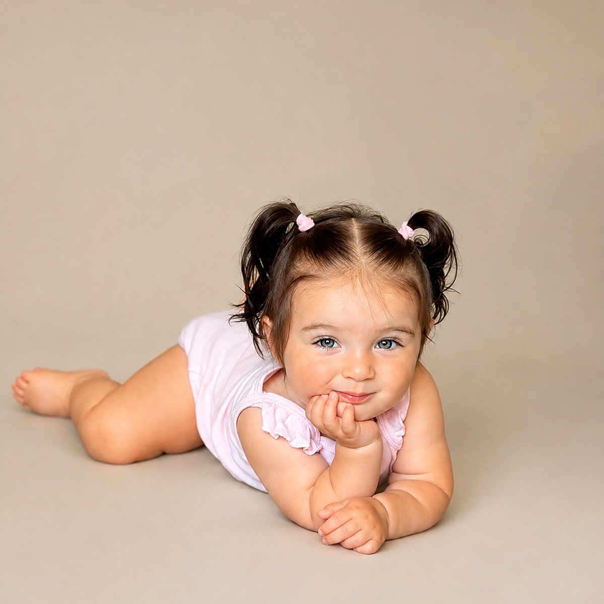 Stella joined the competition — help win amazing prizes! baby, child, pigtails, smile, cute, portrait, infant, lying_down, pink_clothing, skin, face, hand, cheek, blue_eyes, studio, neutral_background, happy, young_child, toddler, girl