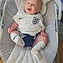 baby, infant, smile, sport_clothing, england_football_kit, baby_rocker, cushion, toy, floor, wooden_floor, happy, child, person, sock, footwear, indoor, seat, head, face, cute
