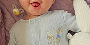 Keegan joined the competition — help win amazing prizes! baby, infant, onesie, blanket, stuffed_animal, bunny, soft_texture, cute, playful, smiling, lying_down, child, face, blue_clothing, pacifier, plush_toy, indoor, young_child, happy, cozy