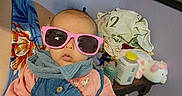 Melesia is registered to the contest to win money with this photo: adult, baby, baby_bottle, button, child, clothing, denim_outfit, face, floor, hand, indoor, painting, person, pink_sunglasses, power_outlet, room, scarf, stuffed_animal, table, wall