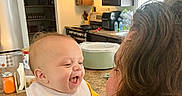 Silas is registered to the contest to win money with this photo: adult, appliance, baby, babylaughing, device, electricaldevice, face, female, happy, head, indoors, kitchen, lamp, people, person, photography, plant, portrait, refrigerator, woman