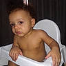baby, child, high_chair, portrait, sitting, indoors, curly_hair, bare_chested, serious, face, eyes, hands, arms, legs, white_chair, curtains, window, home, infant, photography