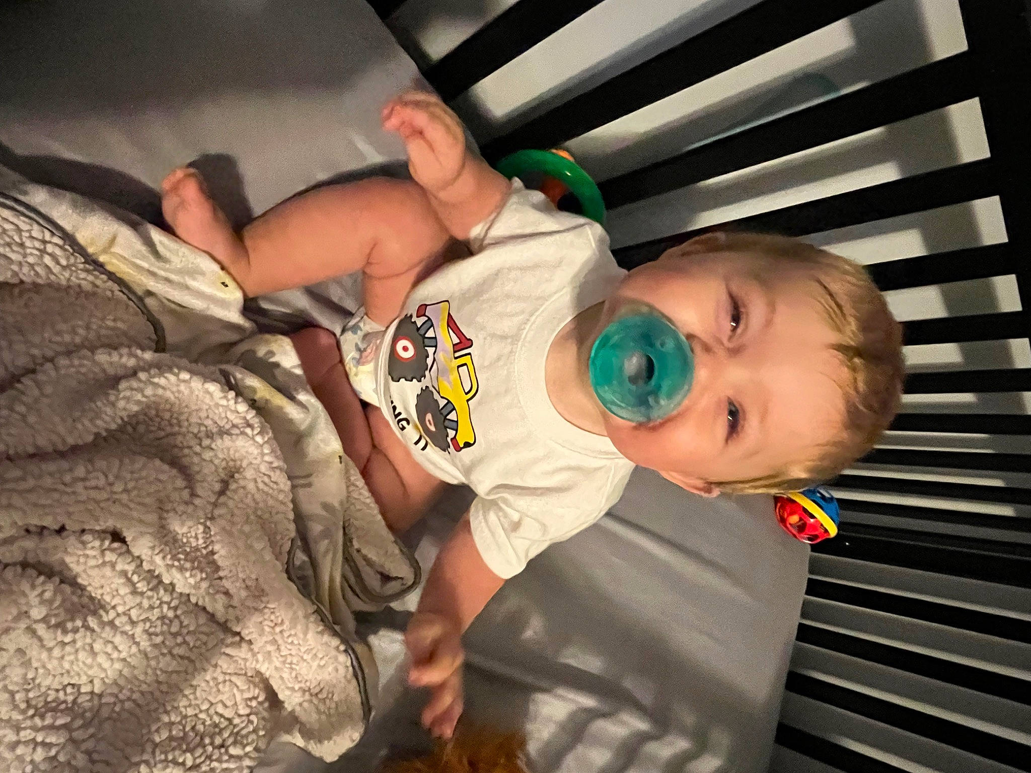 Karter is registered to the contest to win money with this photo: baby, baby_products, baby_safety, baby_toddler_clothing, child, comfort, cradle, elbow, fun, human_body, infant_bed, person, room, sitting, skin, sleeve, toddler, wood