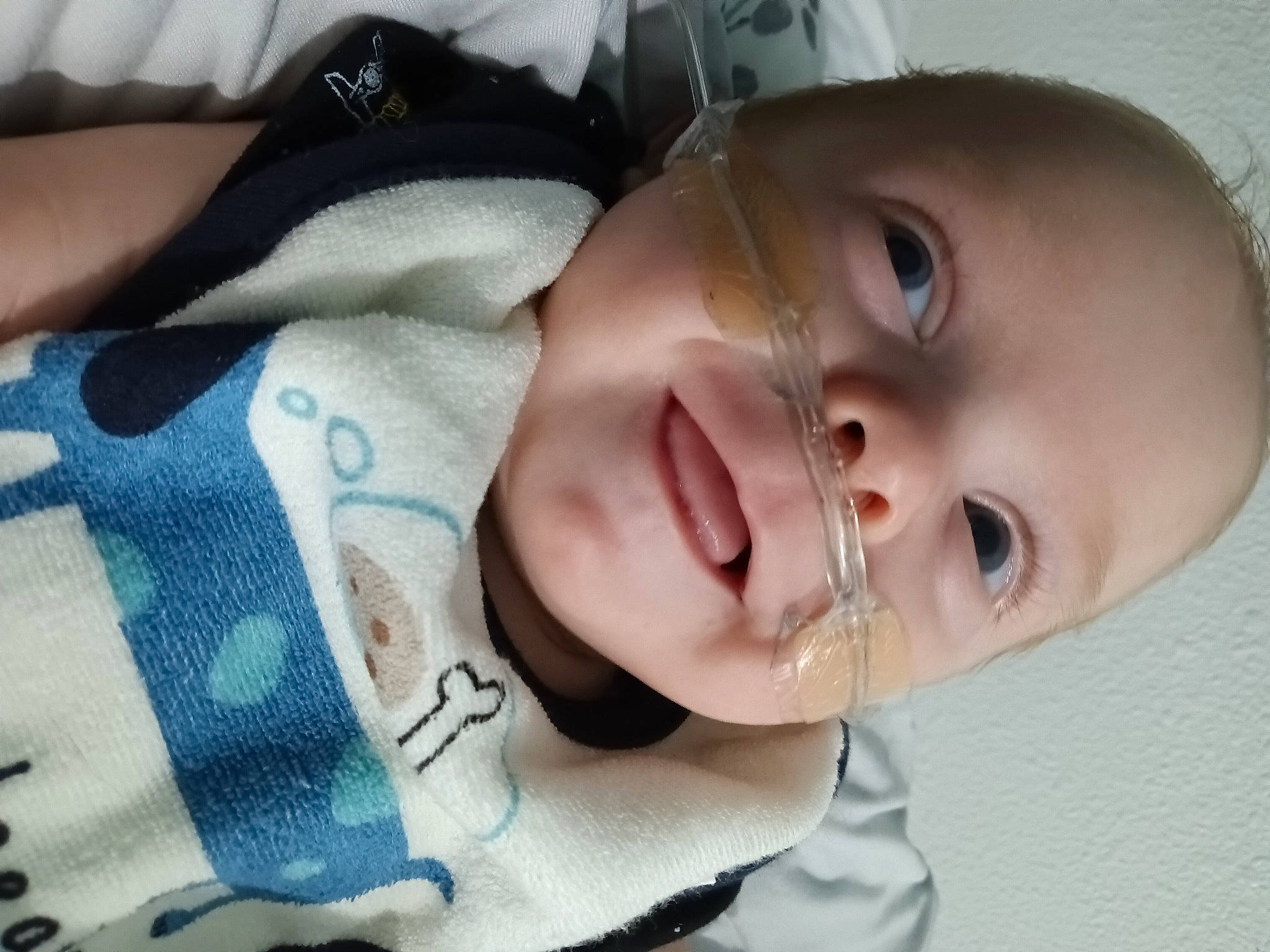 Aryan is registered to the contest to win money with this photo: baby, baby_products, baby_toddler_clothing, cheek, child, chin, comfort, eyebrow, eyelash, face, happy, iris, linens, lip, mouth, nose, person, skin, sleeve, smile