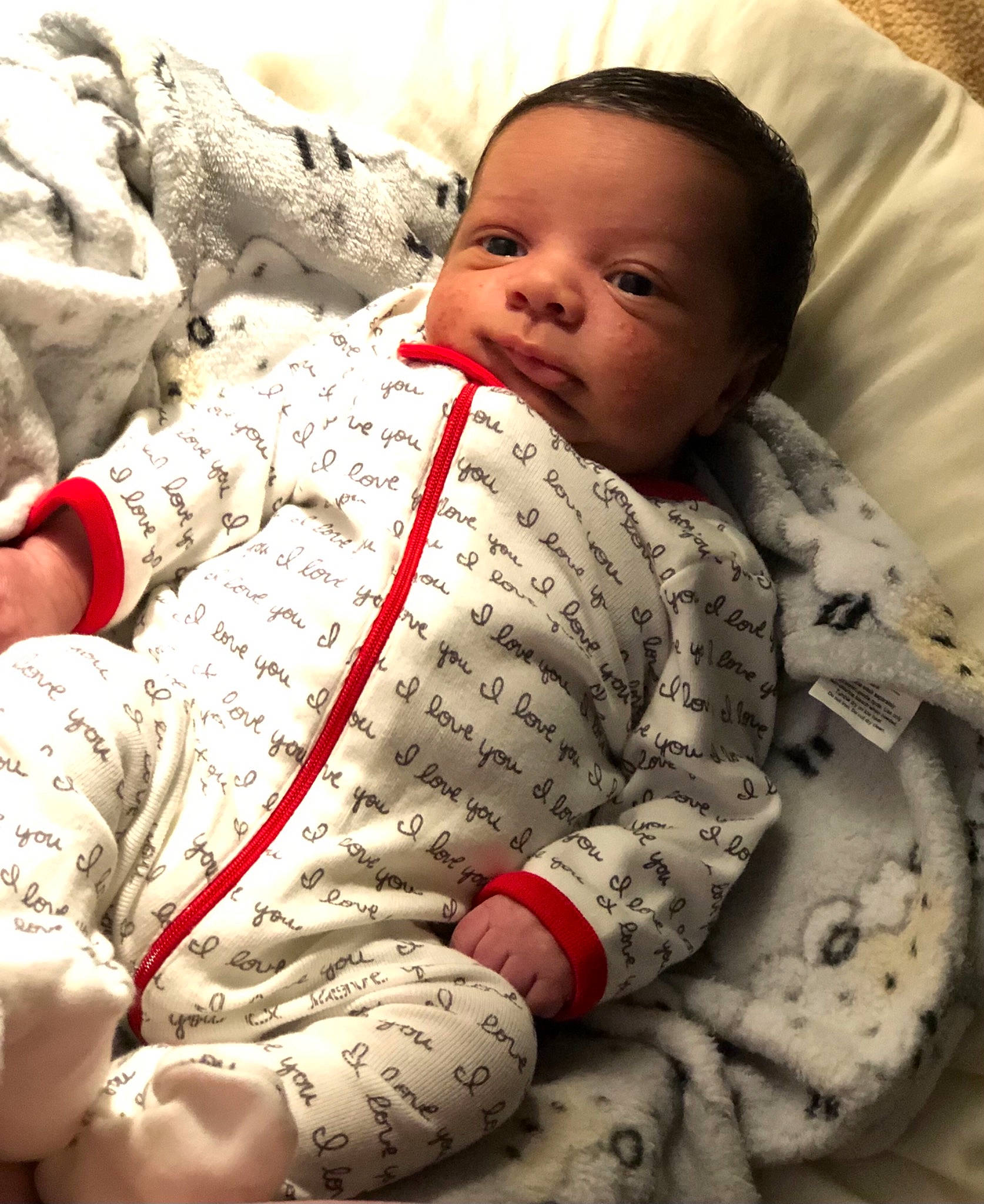 Brysen is registered to the contest to win money with this photo: adaptation, baby, baby_products, baby_sleeping, baby_toddler_clothing, cheek, child, comfort, face, facial_expression, finger, happy, head, linens, mouth, pattern, person, sitting, skin, sleeve