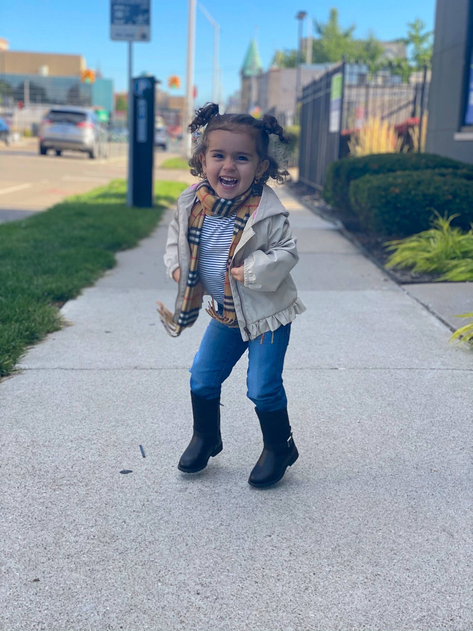 Ava is registered to the contest to win money with this photo: asphalt, child, denim, footwear, fun, jacket, jeans, outerwear, person, photography, plant, recreation, shoe, smile, snapshot, standing, textile, toddler, tree, vacation
