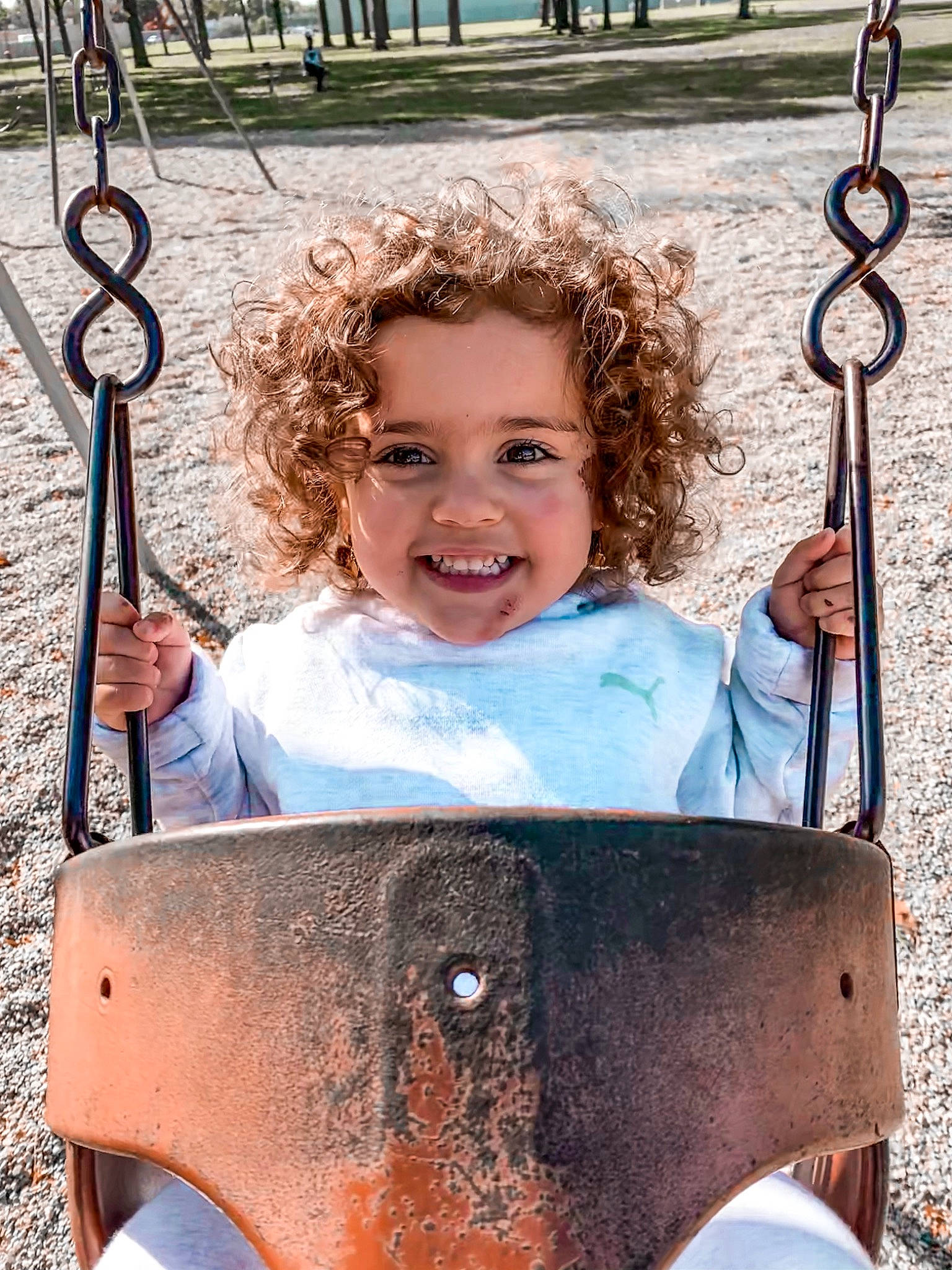 Ava joined the competition — help win amazing prizes! child, fun, joy, outdoor_play_equipment, person, playground, public_space, smile, swing, toddler, vacation