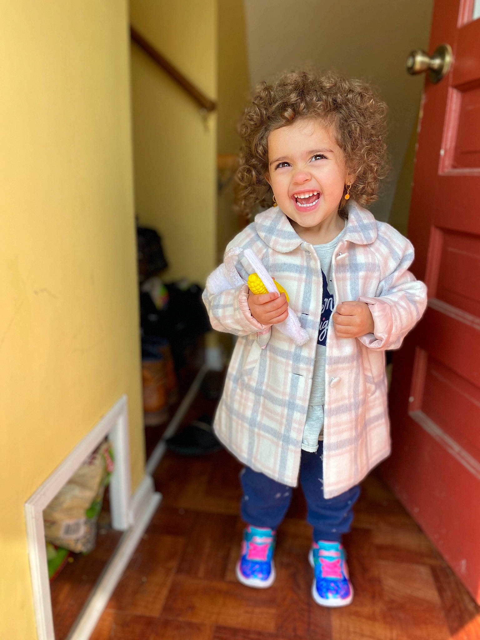 Ava is registered to the contest to win money with this photo: child, outerwear, pajamas, person, play, shoe, smile, standing, toddler, toy