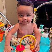 Aries joined the competition — help win amazing prizes! baby, child, activity_center, toy, indoor, curious, hands, face, play, colorful, furniture, television, room, carpet, expression, person, young_child, infant, entertainment, cute