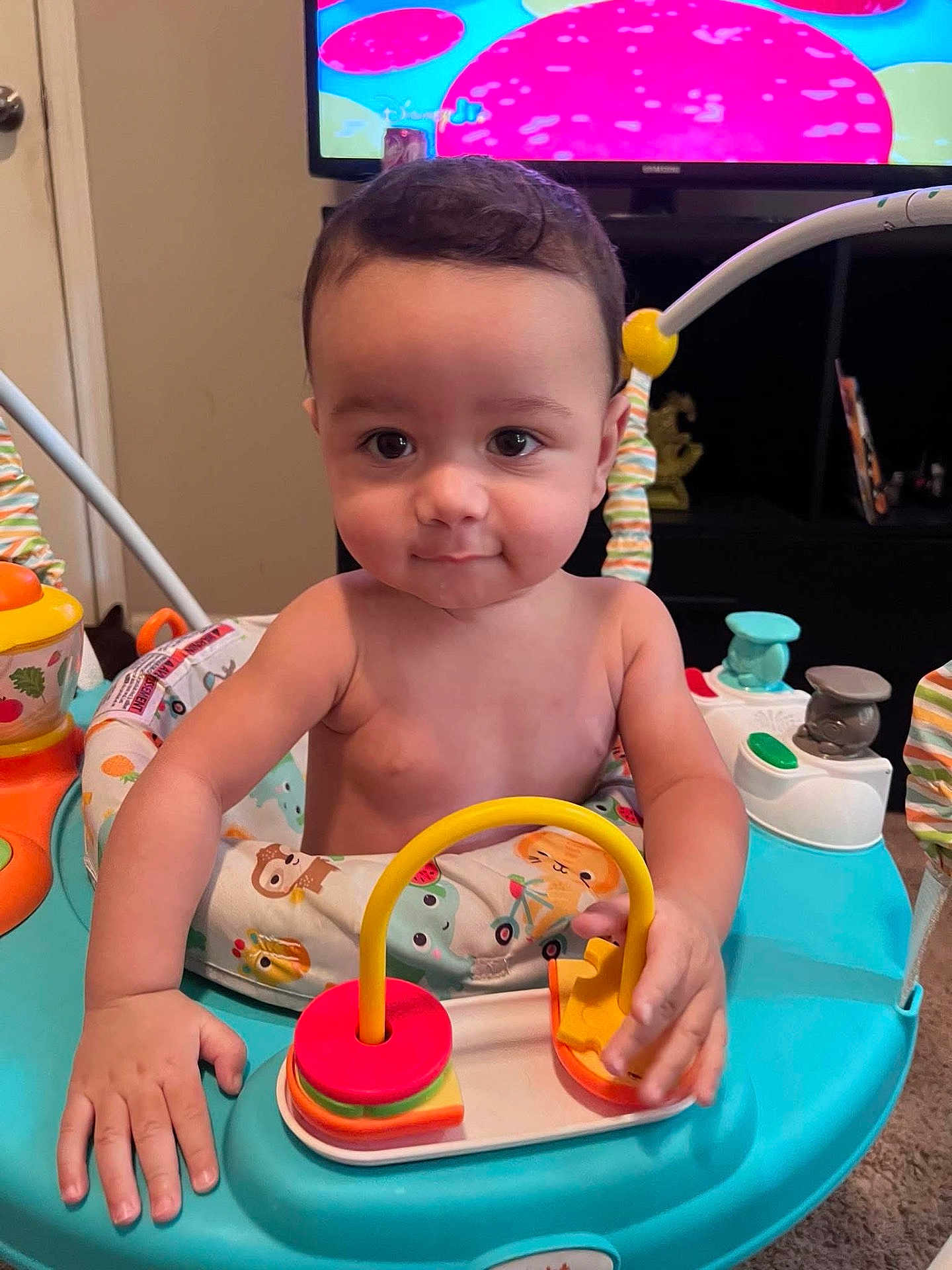 Aries joined the competition — help win amazing prizes! baby, child, activity_center, toy, indoor, curious, hands, face, play, colorful, furniture, television, room, carpet, expression, person, young_child, infant, entertainment, cute