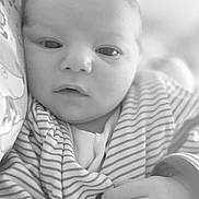 Eyden participe au concours pour gagner de l'argent avec cette photo : baby, infant, face, hand, striped_clothing, button, black_and_white, close_up, expression, curious, soft_background, blue_heart_emoji, cute, newborn, portrait, indoors, child, person, young, emotion