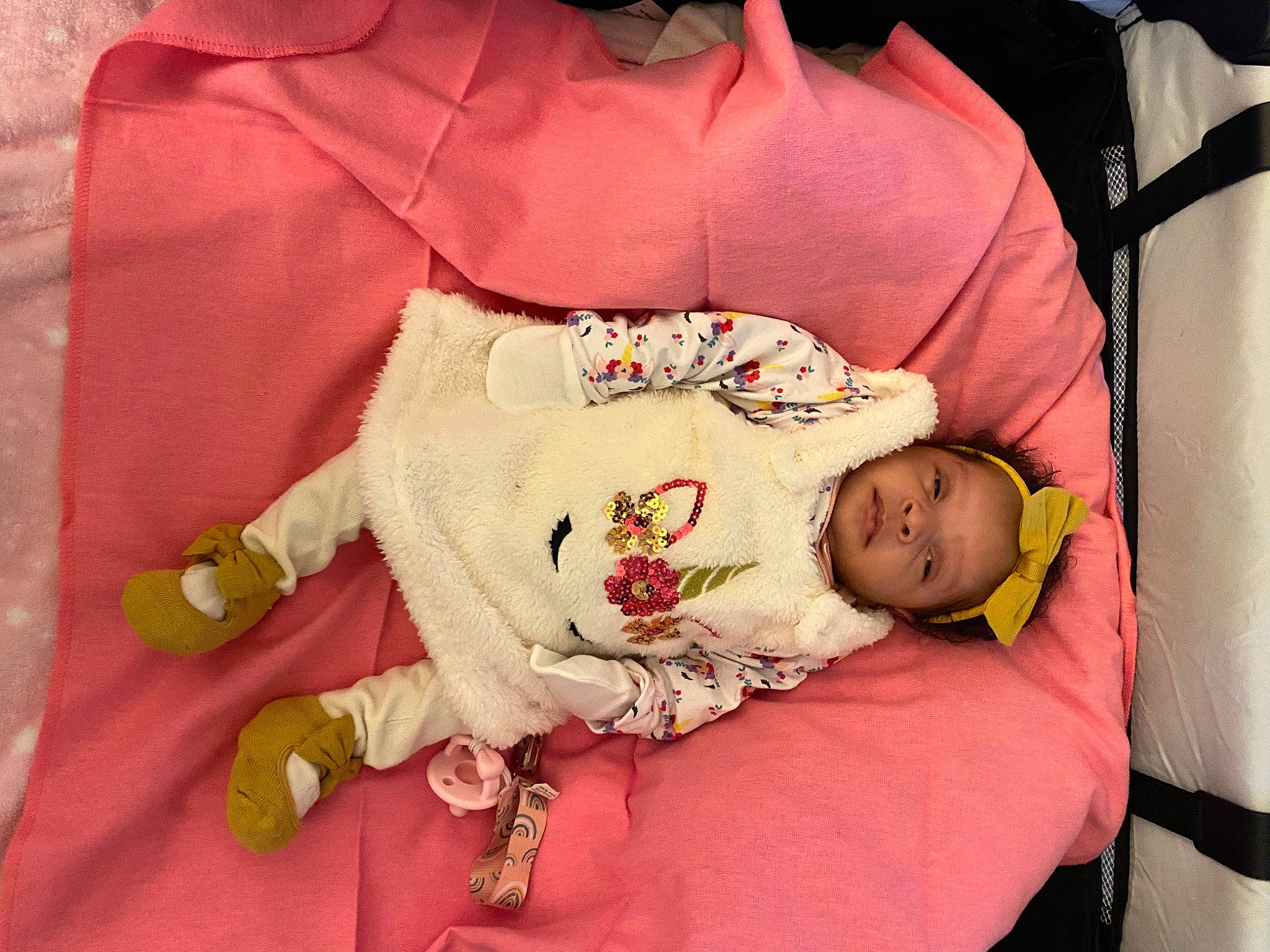 Kendall joined the competition — help win amazing prizes! baby, baby_products, baby_sleeping, baby_toddler_clothing, child, comfort, facial_expression, happy, human_body, linens, magenta, pattern, peach, person, pink, room, sitting, skin, sleeve, textile