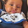 baby, child, infant, bib, mickey_mouse, pout, face, skin, clothing, necklace, adult, black_top, cute, portrait, closeup, chubby_cheeks, hand, person, indoor, casual