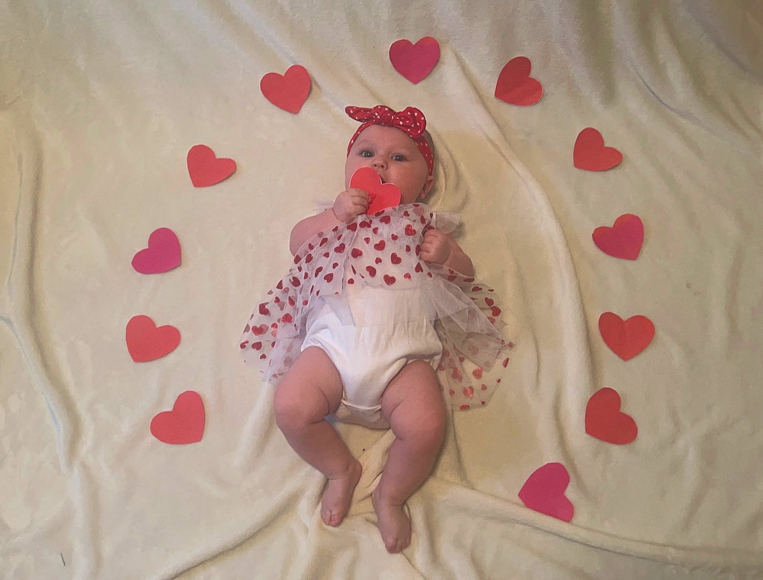 Amelia is registered to the contest to win money with this photo: baby, baby_products, baby_sleeping, baby_toddler_clothing, bed, bed_sheet, bedding, carmine, comfort, headwear, linens, magenta, pattern, peach, person, petal, pink, room, sleeve, sock