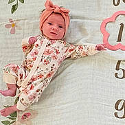 Madolin joined the competition — help win amazing prizes! baby, blanket, bonnet, clothing, face, hat, head, newborn, number, pajamas, person, sitting, sleeve, symbol, text, yawning