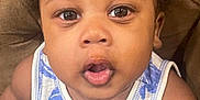 Jayceon is registered to the contest to win money with this photo: accessories, baby, babylaughing, blouse, bodypart, clothing, couch, face, furniture, happy, head, jewelry, mouth, necklace, person, photography, portrait, sitting, smile