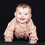 baby, child, smiling, crawling, blue_eyes, peach_outfit, long_sleeves, happy, cute, portrait, indoor, infant, young_child, face, hands, studio_photo, black_background, clothing, person, small_fingers